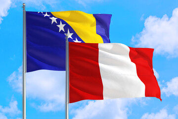 Peru and Bosnia Herzegovina national flag waving in the windy deep blue sky. Diplomacy and international relations concept.