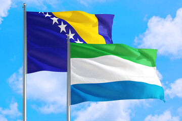 Sierra Leone and Bosnia Herzegovina national flag waving in the windy deep blue sky. Diplomacy and...