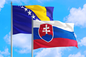 Slovakia and Bosnia Herzegovina national flag waving in the windy deep blue sky. Diplomacy and international relations concept.