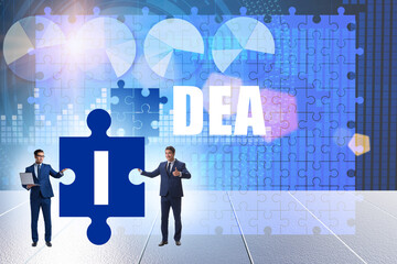 Idea concept with businessman putting jigsaw puzzle