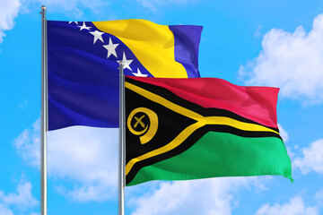 Vanuatu and Bosnia Herzegovina national flag waving in the windy deep blue sky. Diplomacy and international relations concept.