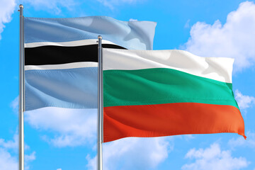 Bulgaria and Botswana national flag waving in the windy deep blue sky. Diplomacy and international relations concept.