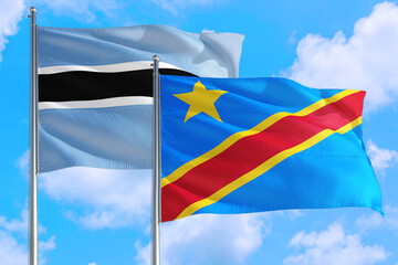 Congo and Botswana national flag waving in the windy deep blue sky. Diplomacy and international relations concept.