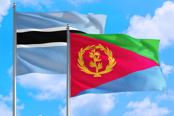 Eritrea and Botswana national flag waving in the windy deep blue sky. Diplomacy and international relations concept.