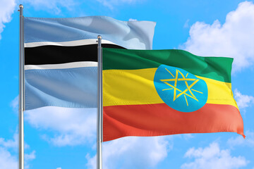 Ethiopia and Botswana national flag waving in the windy deep blue sky. Diplomacy and international relations concept.