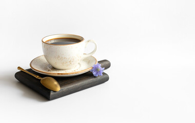 Cup with chicory drink on a wooden tray isolated on a white background. Natural coffee substitute. Space for text.