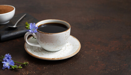 Healthy drink chicory on a dark brown background. Herbal coffee substitute. Copy space. Side view.