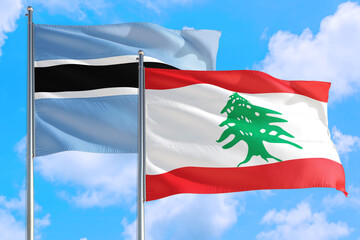 Lebanon and Botswana national flag waving in the windy deep blue sky. Diplomacy and international relations concept.