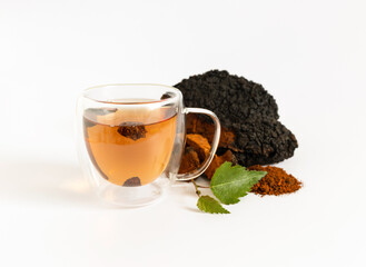 Cup with chaga drink and chaga mushroom isolated on white background. Beverage with birch mushroom.