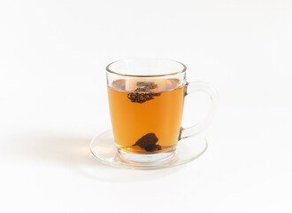 Chaga mushroom tea in a glass cup isolated on a white background. Healthy organic drink.