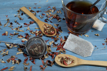 image of infusion leaves, wooden spoon and cup of tea
