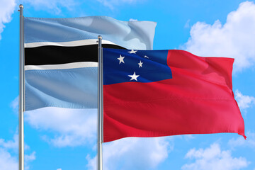 Samoa and Botswana national flag waving in the windy deep blue sky. Diplomacy and international relations concept.