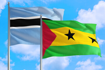 Sao Tome And Principe and Botswana national flag waving in the windy deep blue sky. Diplomacy and...