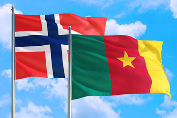 Cameroon and Bouvet Islands national flag waving in the windy deep blue sky. Diplomacy and international relations concept.