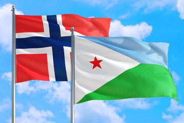 Djibouti and Bouvet Islands national flag waving in the windy deep blue sky. Diplomacy and international relations concept.