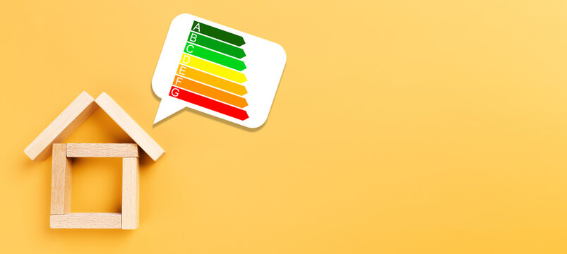 house made of wooden blocks next to energy efficiency rating on bright background - Powered by Adobe