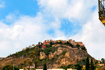 Fototapeta na wymiar The Architecture and Churches of the city of Taormina on the island of Sicily.The site of the old town is about 300 m above the sea, while a very steep and almost isolated rock, crowned by a Saracen c