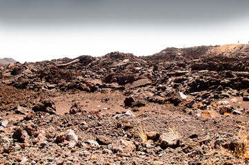 The lava covered slopes of the volcano Mount Etna in Sicily Italy. Etna is an active stratovolcano on the east coast of Sicily, close to Messina and Catania. It is the largest active volcano in Europe