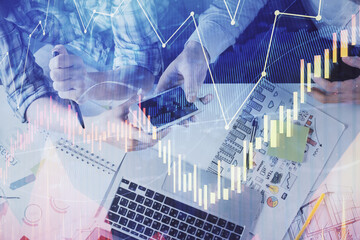 Double exposure of forex graph drawing and man and woman working together holding and using a mobile device. Trade concept.