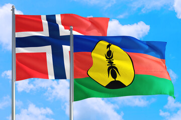 New Caledonia and Bouvet Islands national flag waving in the windy deep blue sky. Diplomacy and international relations concept.