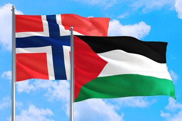 Palestine and Bouvet Islands national flag waving in the windy deep blue sky. Diplomacy and international relations concept.