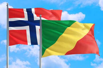 Republic Of The Congo and Bouvet Islands national flag waving in the windy deep blue sky. Diplomacy and international relations concept.