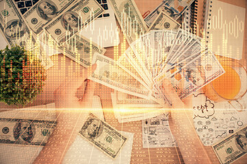 Multi exposure of financial graph drawing hologram and USA dollars bills and man hands. Analysis concept.