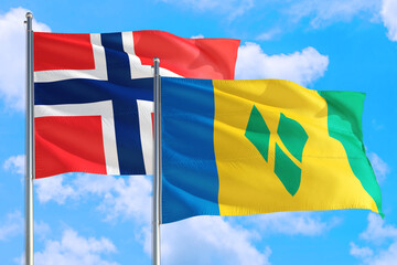 Saint Vincent And The Grenadines and Bouvet Islands national flag waving in the windy deep blue...