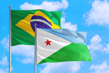 Dominica and Brazil national flag waving in the windy deep blue sky. Diplomacy and international relations concept.