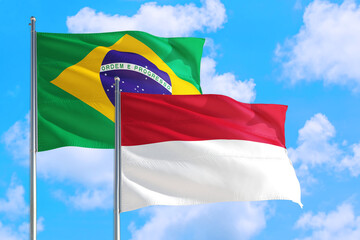 Iran and Brazil national flag waving in the windy deep blue sky. Diplomacy and international relations concept.