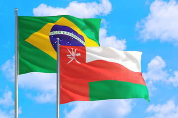 Pakistan and Brazil national flag waving in the windy deep blue sky. Diplomacy and international relations concept.