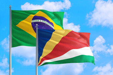 Sierra Leone and Brazil national flag waving in the windy deep blue sky. Diplomacy and international relations concept.