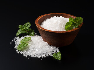 Himalayan rock salt and mint on a black background