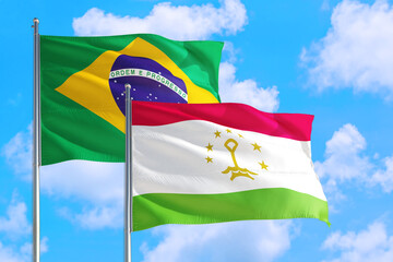 Tanzania and Brazil national flag waving in the windy deep blue sky. Diplomacy and international relations concept.
