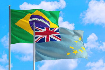 Uganda and Brazil national flag waving in the windy deep blue sky. Diplomacy and international relations concept.
