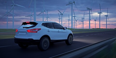 Electric vehicle driving through a wind farm at night.