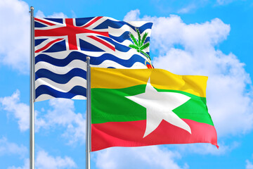 Myanmar and British Indian Ocean Territory national flag waving in blue sky. Diplomacy and international relations concept.