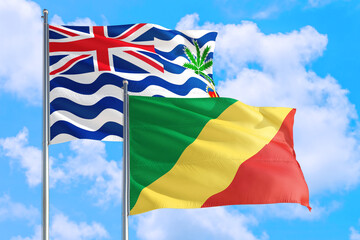 Republic Of The Congo and British Indian Ocean Territory national flag waving in blue sky. Diplomacy and international relations concept.