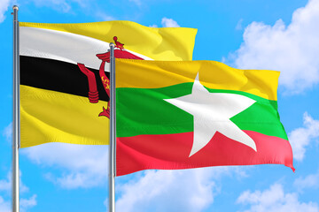 Myanmar and Brunei national flag waving in the windy deep blue sky. Diplomacy and international relations concept.