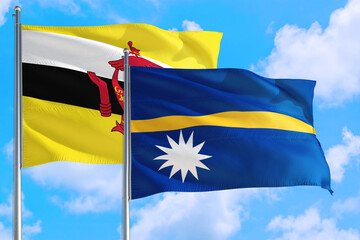 Nauru and Brunei national flag waving in the windy deep blue sky. Diplomacy and international relations concept.