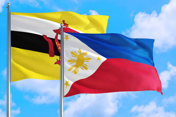 Philippines and Brunei national flag waving in the windy deep blue sky. Diplomacy and international relations concept.