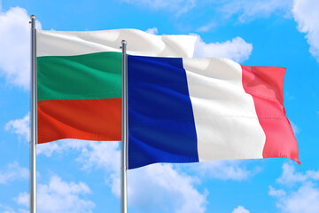 France and Bulgaria national flag waving in the windy deep blue sky. Diplomacy and international relations concept.