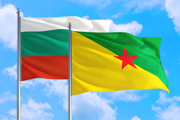French Guiana and Bulgaria national flag waving in the windy deep blue sky. Diplomacy and international relations concept.