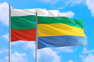 Gabon and Bulgaria national flag waving in the windy deep blue sky. Diplomacy and international...