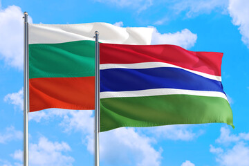 Gambia and Bulgaria national flag waving in the windy deep blue sky. Diplomacy and international relations concept.