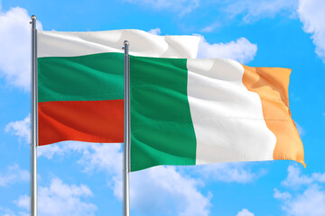 Ireland and Bulgaria national flag waving in the windy deep blue sky. Diplomacy and international relations concept.