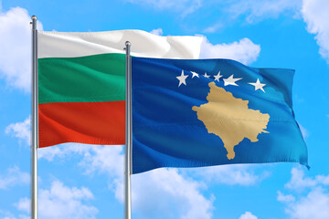 Kosovo and Bulgaria national flag waving in the windy deep blue sky. Diplomacy and international relations concept.