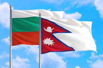 Naklejka na ściany i meble Nepal and Bulgaria national flag waving in the windy deep blue sky. Diplomacy and international relations concept.