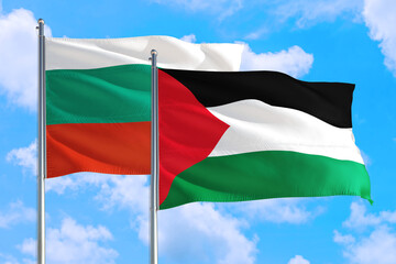 Palestine and Bulgaria national flag waving in the windy deep blue sky. Diplomacy and international relations concept.