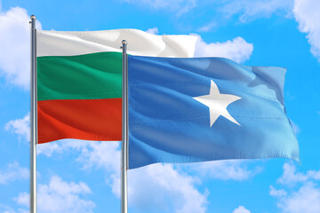 Somalia and Bulgaria national flag waving in the windy deep blue sky. Diplomacy and international relations concept.